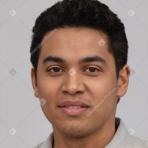 Joyful latino young-adult male with short  black hair and brown eyes