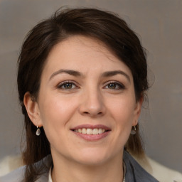 Joyful white young-adult female with medium  brown hair and brown eyes