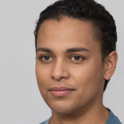 Joyful latino young-adult male with short  brown hair and brown eyes