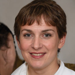 Joyful white adult female with medium  brown hair and brown eyes