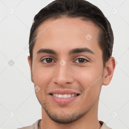 Joyful white young-adult male with short  brown hair and brown eyes