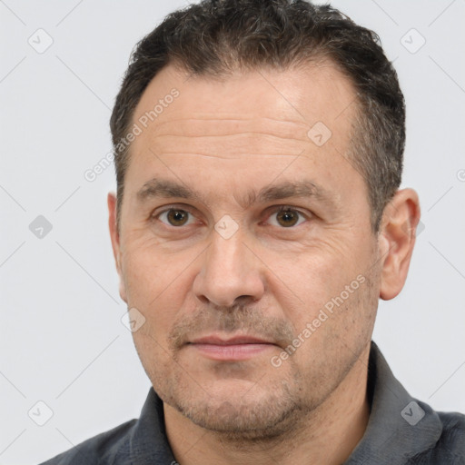 Joyful white adult male with short  brown hair and brown eyes