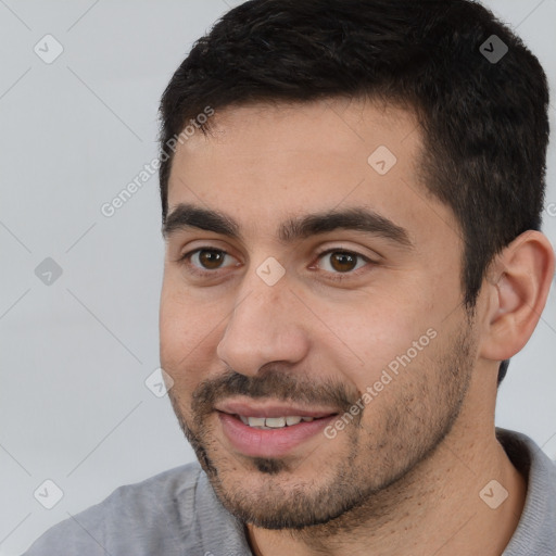 Joyful white young-adult male with short  black hair and brown eyes