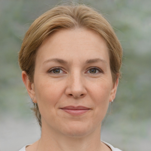 Joyful white adult female with medium  brown hair and grey eyes