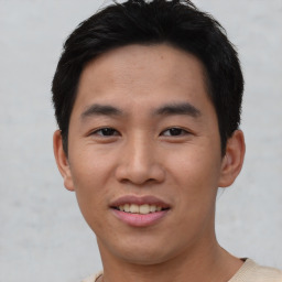 Joyful asian young-adult male with short  brown hair and brown eyes