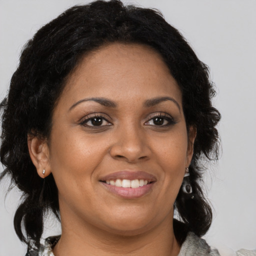 Joyful black young-adult female with medium  brown hair and brown eyes