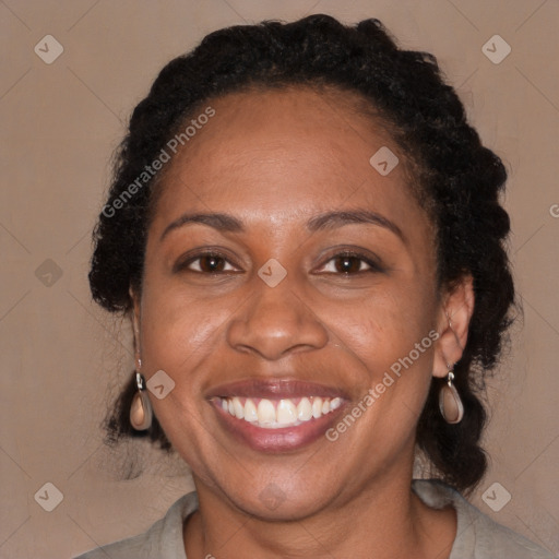 Joyful black adult female with medium  brown hair and brown eyes