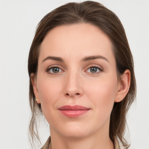 Joyful white young-adult female with medium  brown hair and grey eyes