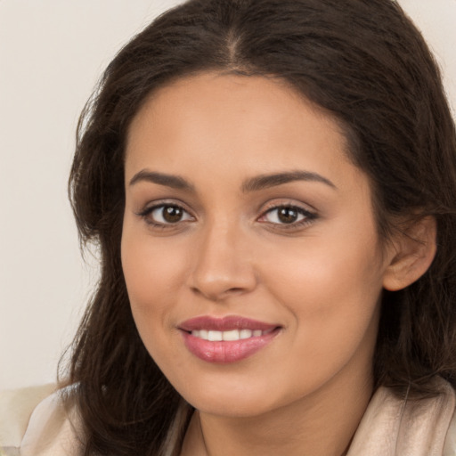 Joyful white young-adult female with long  brown hair and brown eyes