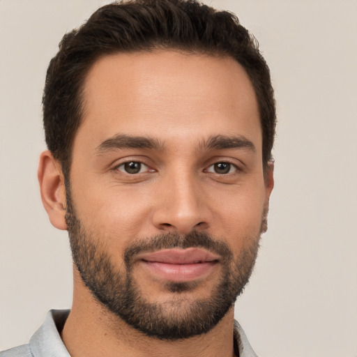 Joyful white young-adult male with short  brown hair and brown eyes