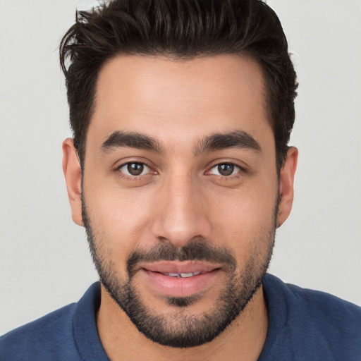 Joyful white young-adult male with short  black hair and brown eyes