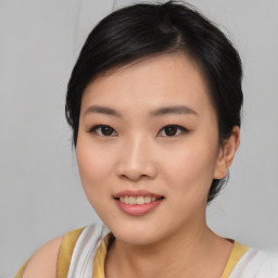 Joyful asian young-adult female with medium  black hair and brown eyes