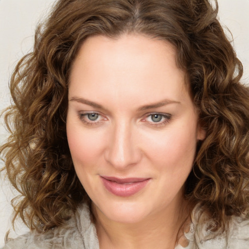 Joyful white young-adult female with medium  brown hair and green eyes