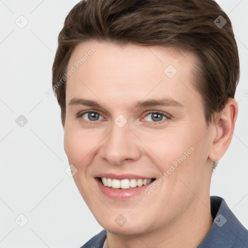 Joyful white young-adult female with short  brown hair and grey eyes