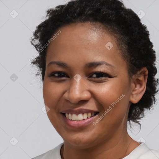 Joyful black young-adult female with short  brown hair and brown eyes