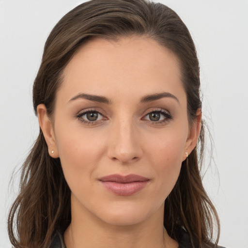 Joyful white young-adult female with long  brown hair and brown eyes