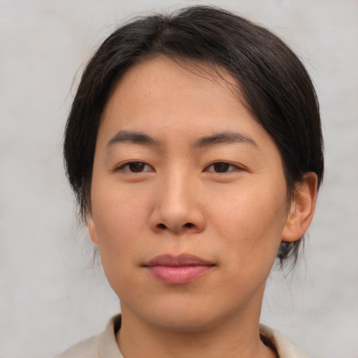 Joyful asian young-adult female with medium  brown hair and brown eyes