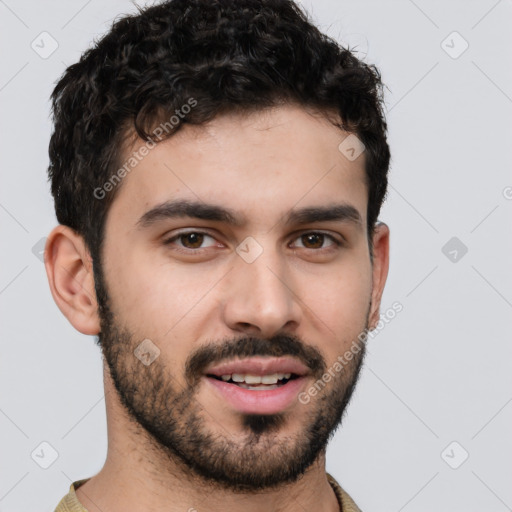 Joyful white young-adult male with short  black hair and brown eyes