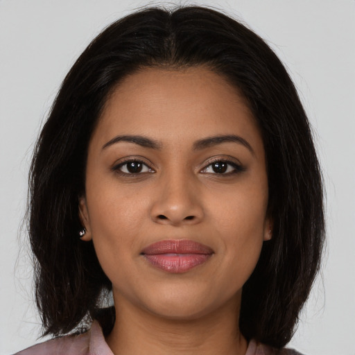 Joyful latino young-adult female with long  brown hair and brown eyes