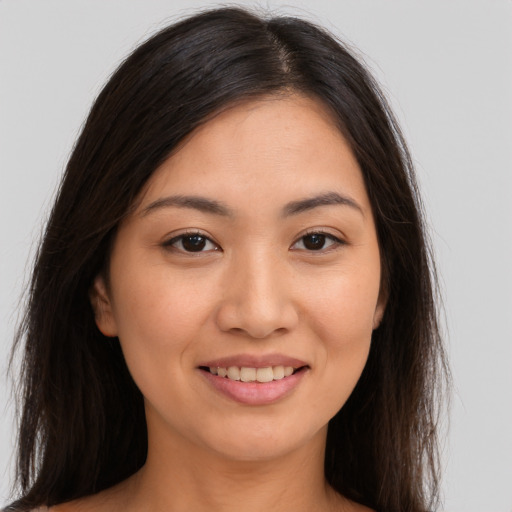 Joyful white young-adult female with long  brown hair and brown eyes