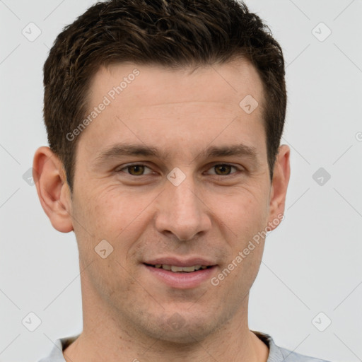 Joyful white young-adult male with short  brown hair and grey eyes