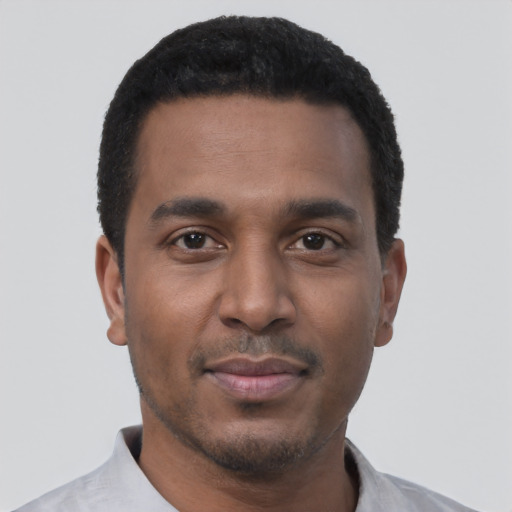 Joyful black young-adult male with short  black hair and brown eyes