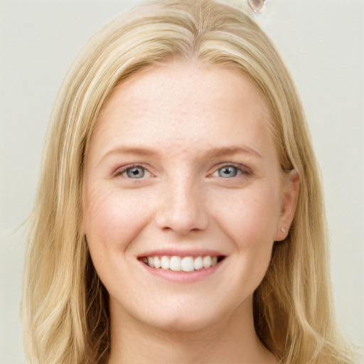 Joyful white young-adult female with long  brown hair and blue eyes