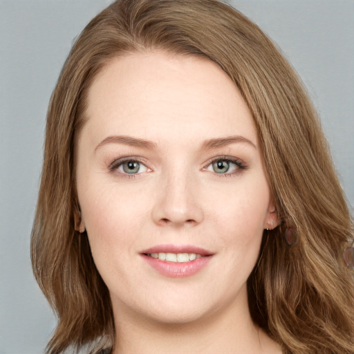 Joyful white young-adult female with long  brown hair and blue eyes