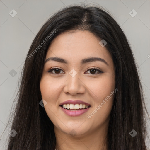 Joyful latino young-adult female with long  brown hair and brown eyes