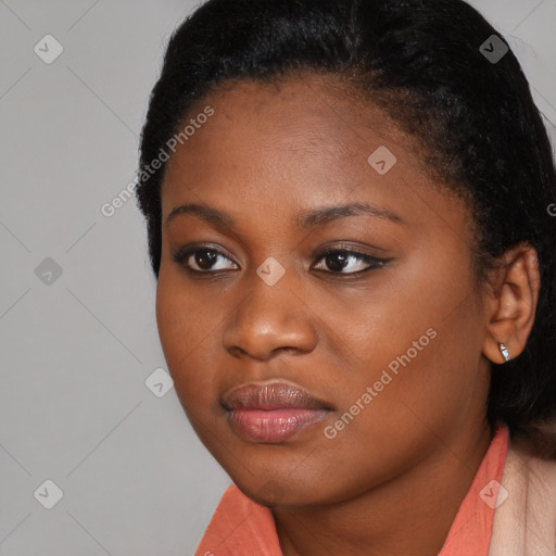 Joyful black young-adult female with long  black hair and brown eyes