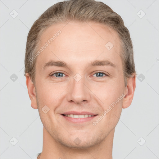 Joyful white young-adult male with short  brown hair and grey eyes