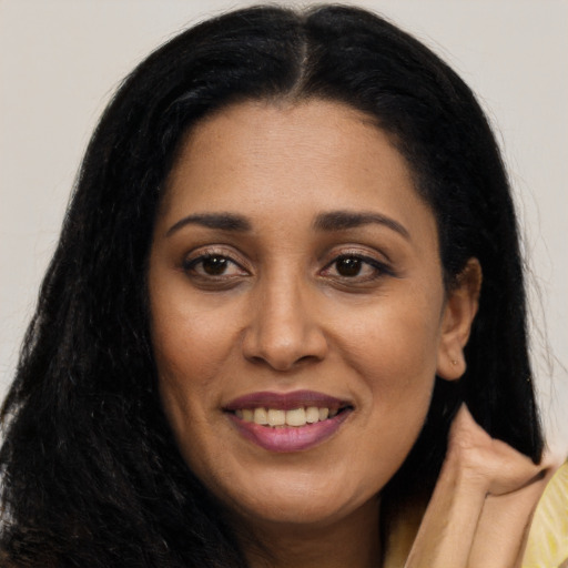 Joyful latino young-adult female with long  black hair and brown eyes