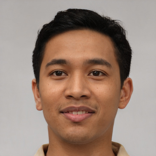 Joyful asian young-adult male with short  black hair and brown eyes