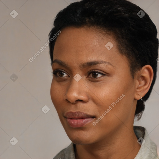 Joyful black young-adult female with short  black hair and brown eyes