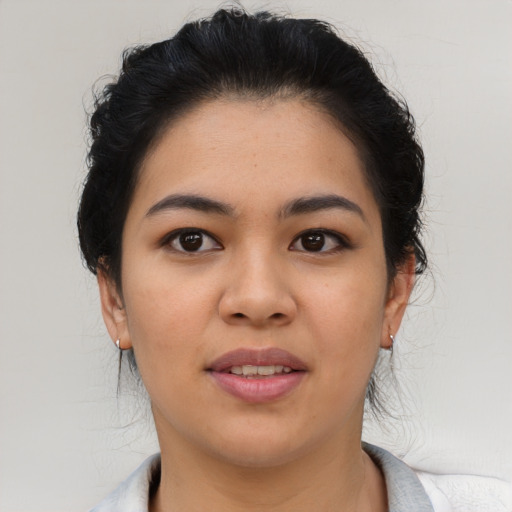 Joyful latino young-adult female with short  brown hair and brown eyes
