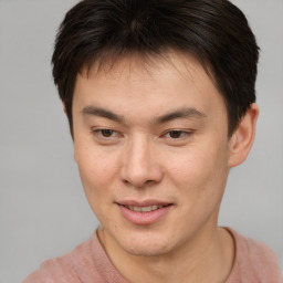 Joyful asian young-adult male with short  brown hair and brown eyes