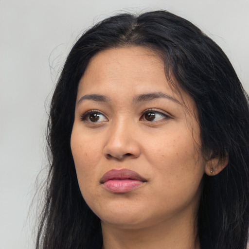 Joyful latino young-adult female with long  black hair and brown eyes