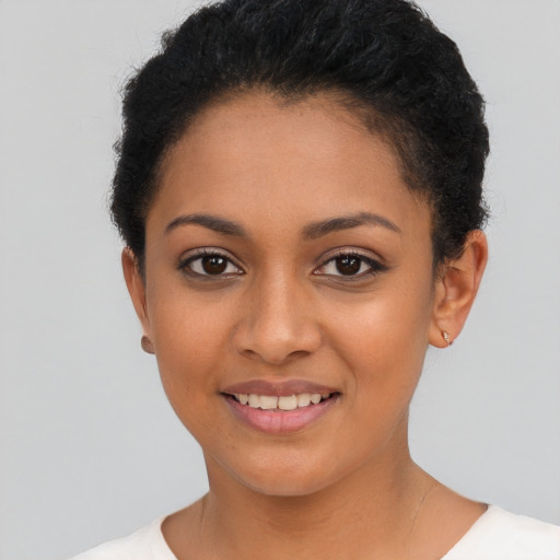Joyful latino young-adult female with short  black hair and brown eyes
