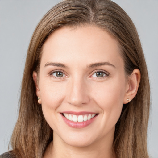 Joyful white young-adult female with long  brown hair and grey eyes