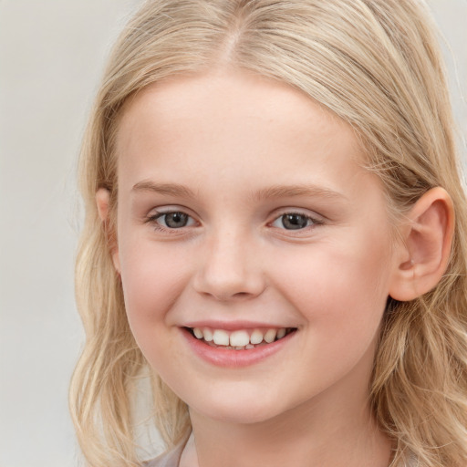 Joyful white child female with long  blond hair and brown eyes