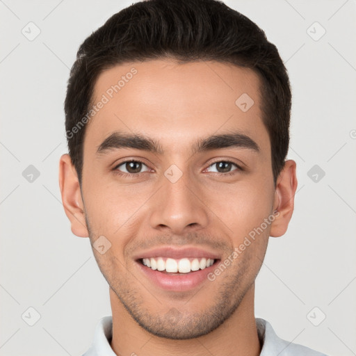 Joyful white young-adult male with short  brown hair and brown eyes