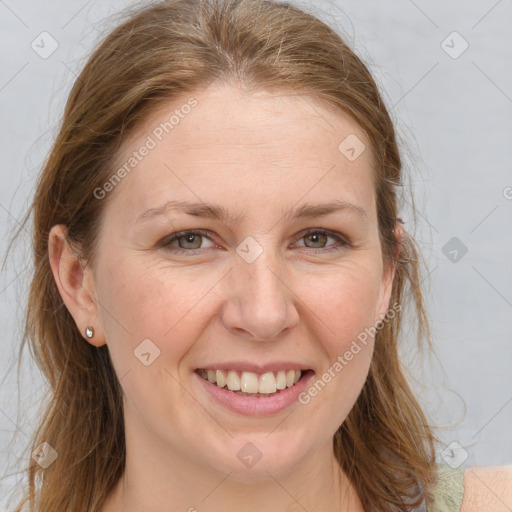 Joyful white adult female with medium  brown hair and grey eyes