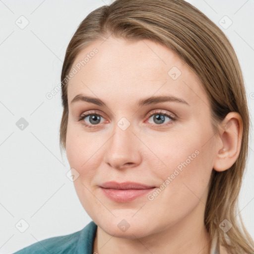 Joyful white young-adult female with medium  brown hair and blue eyes