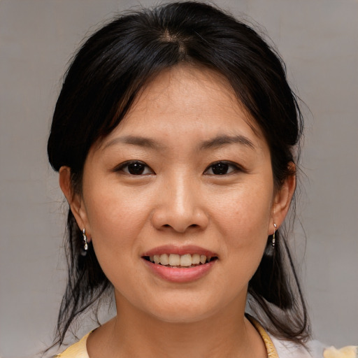 Joyful asian young-adult female with medium  brown hair and brown eyes
