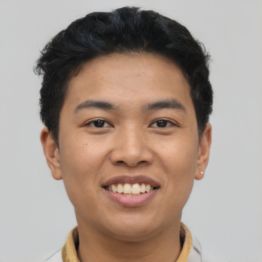 Joyful asian young-adult male with short  brown hair and brown eyes