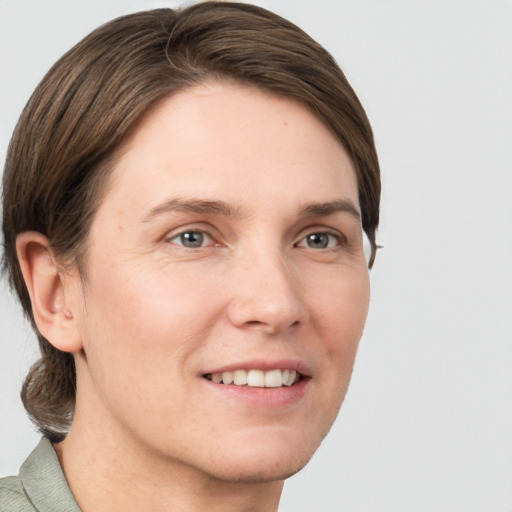 Joyful white young-adult female with short  brown hair and grey eyes