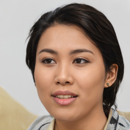 Joyful asian young-adult female with medium  black hair and brown eyes