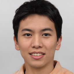 Joyful asian young-adult male with short  brown hair and brown eyes