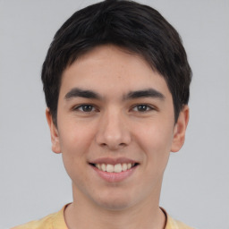 Joyful asian young-adult male with short  black hair and brown eyes