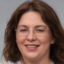 Joyful white adult female with long  brown hair and brown eyes